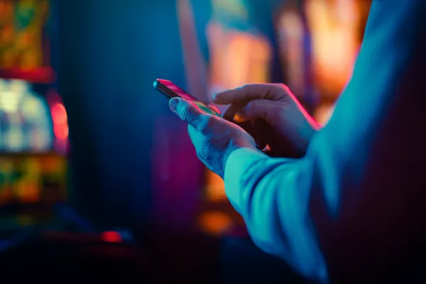 A woman in a luxurious green gown next to an ornate roulette wheel, capturing the upscale casino mood of JL77.